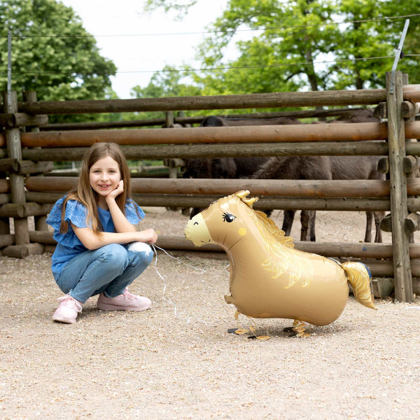 Young girl with a foil balloon horse, pony in a farm setting, 54x96 cm, walking on air, helium inflated, cute decor.